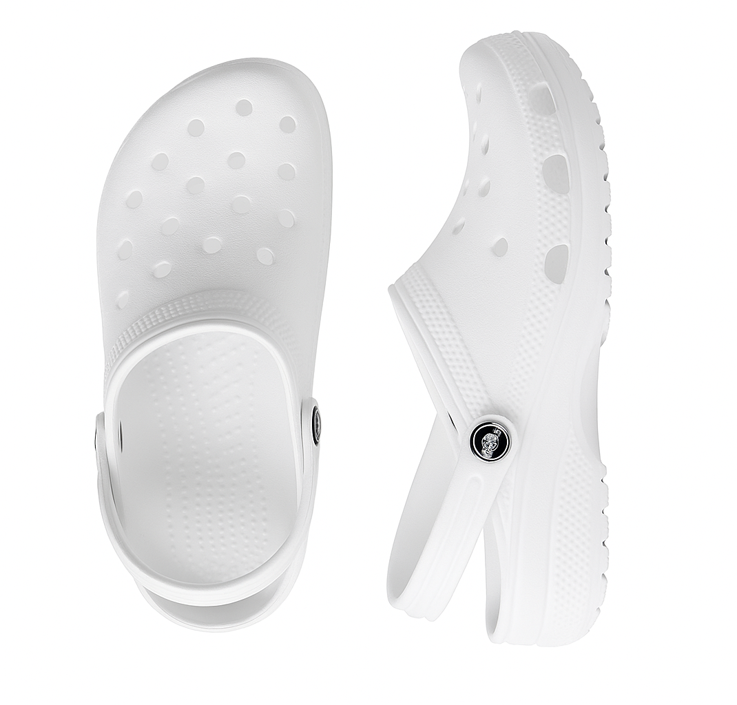 White clogs with a button on a white background