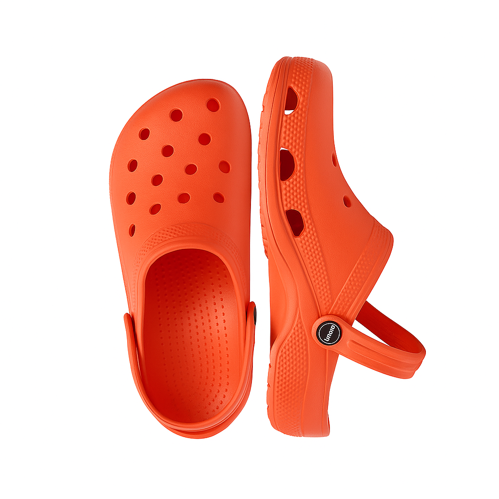 Orange clogs with a strap on a white background