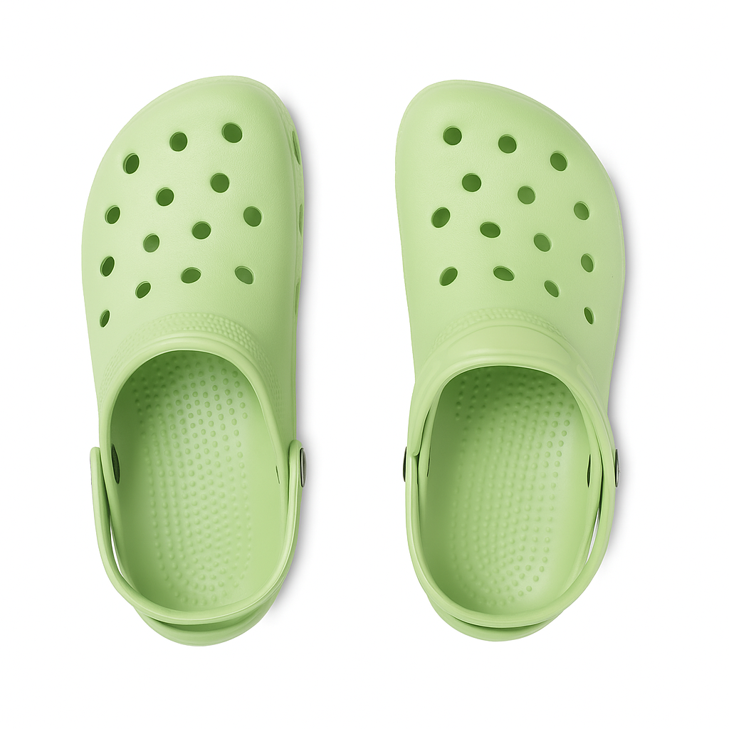 Pair of light green clogs on a white background