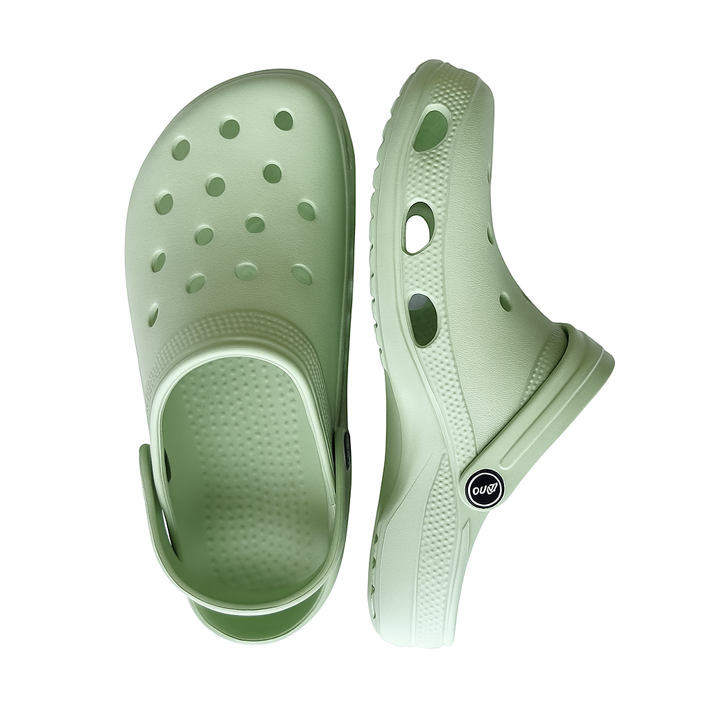 Pair of light green clogs on a white background